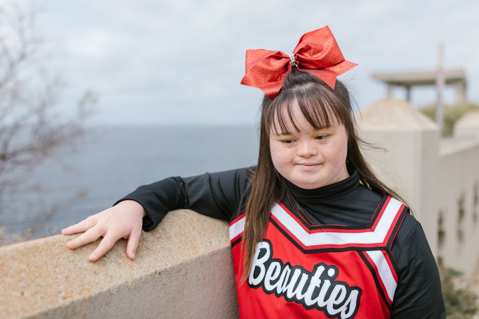 a young cheerleader with down syndrome poses confidently out