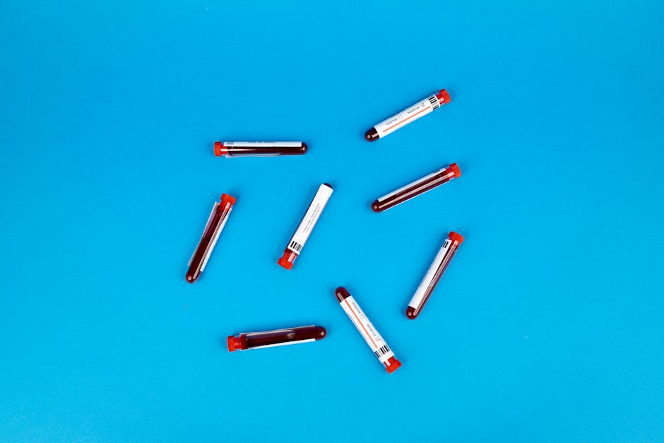 multiple blood sample tubes arranged on a vivid blue backgro
